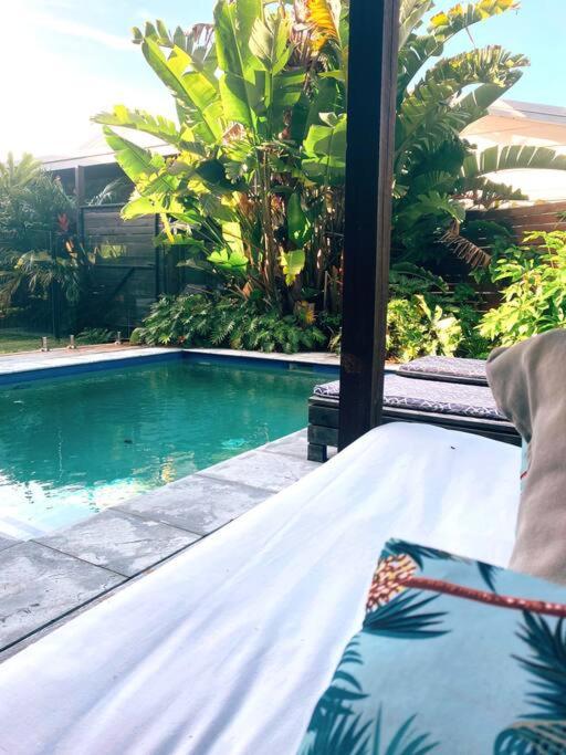 a view of a swimming pool from a porch at CC's @ Byron Self Contained Studio in Byron Bay