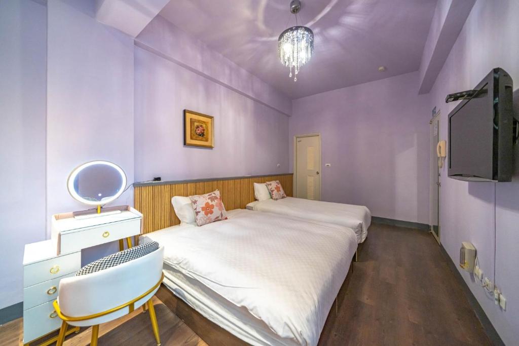a purple bedroom with a large bed and a tv at Sunny Homestay in Ji&#39;an