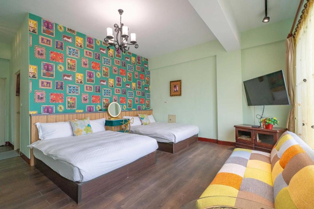 a bedroom with two beds and a wall with pictures at Sunny Homestay in Ji&#39;an