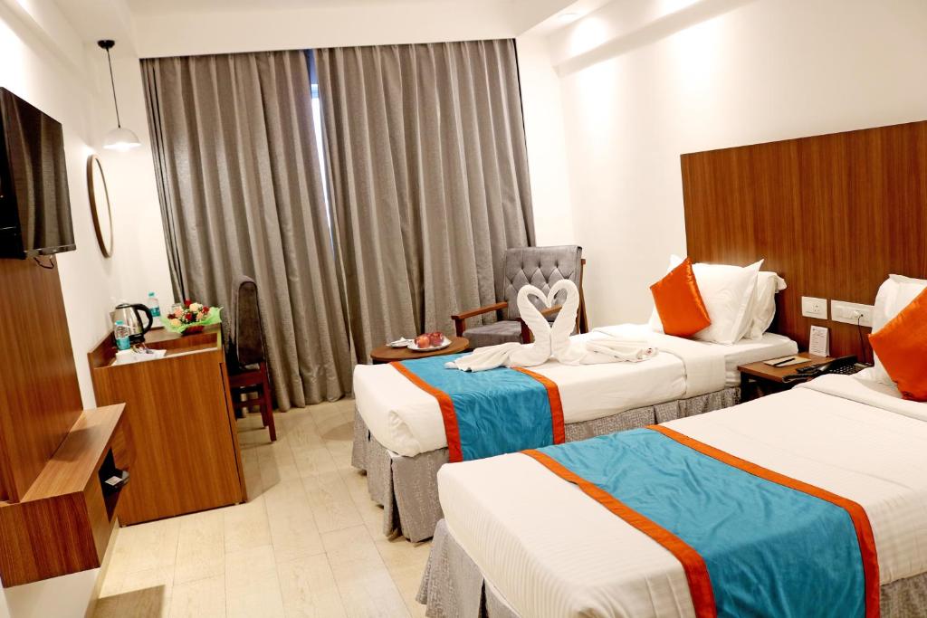 Postel nebo postele na pokoji v ubytování Ramee Guestline Tirupati