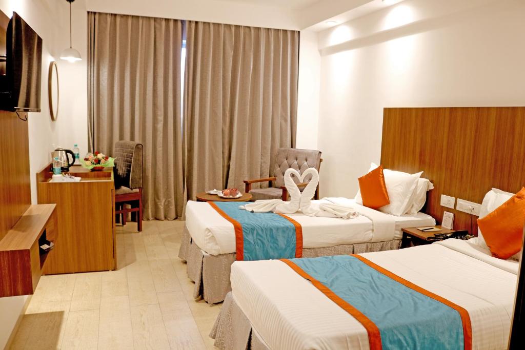 Postel nebo postele na pokoji v ubytování Ramee Guestline Tirupati