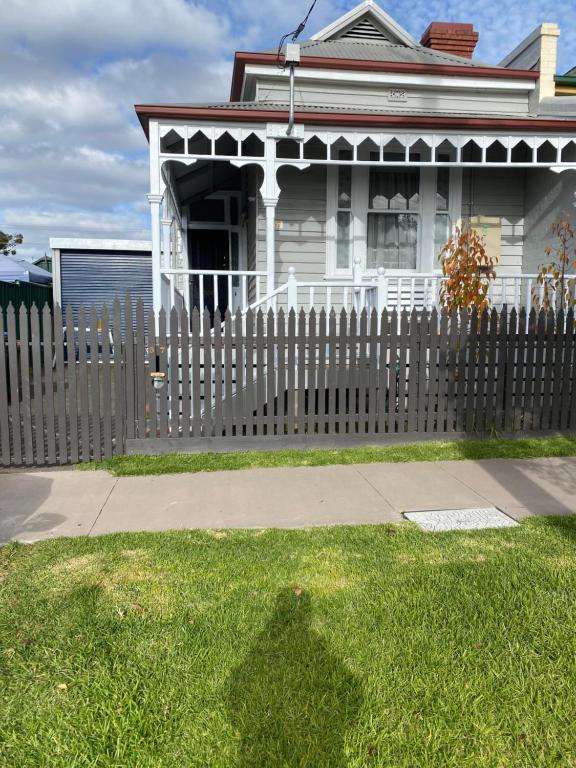 a wooden fence in front of a house at Freshly renovated gem - 1.5km from the city centre in Quarry Hill