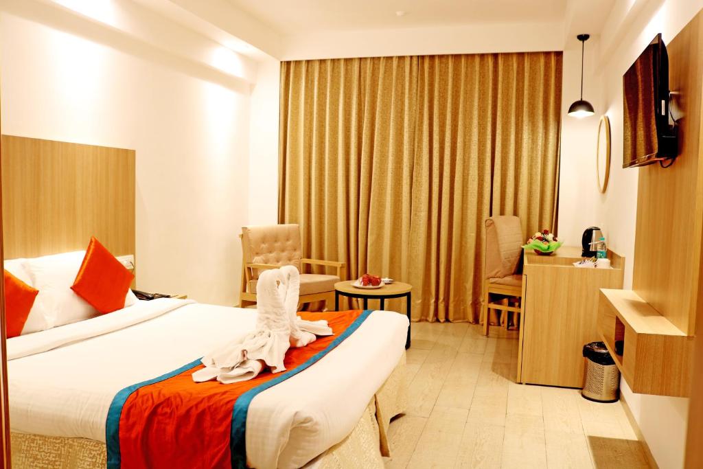 Postel nebo postele na pokoji v ubytování Ramee Guestline Tirupati