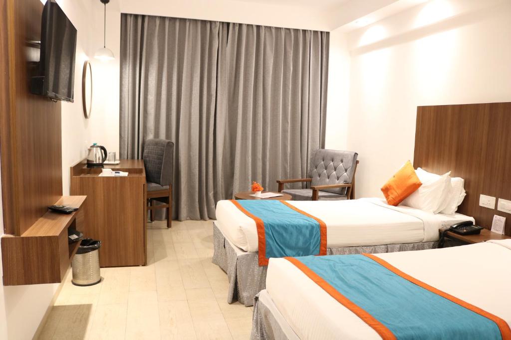 Postel nebo postele na pokoji v ubytování Ramee Guestline Tirupati