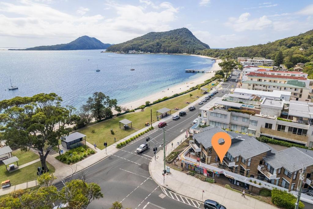 an aerial view of a city and a beach at Fleetwood 3 63 Shoal Bay Road Relaxed living with water views overlooking Shoal Bay in Shoal Bay