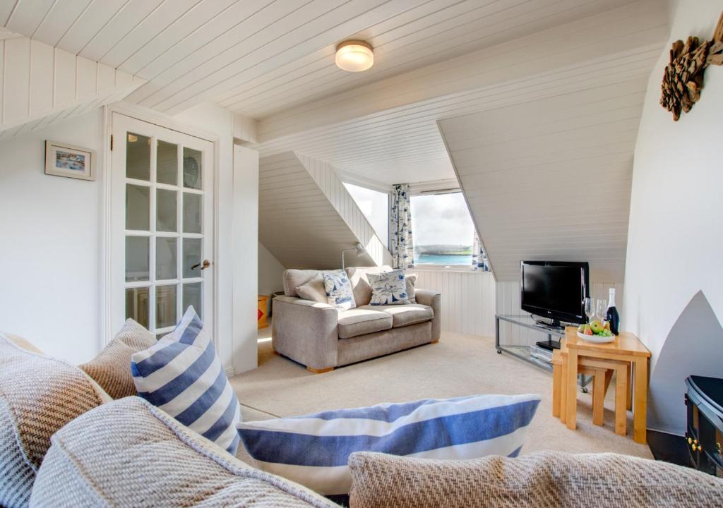 a living room with a couch and a tv at 12 New Street in Padstow