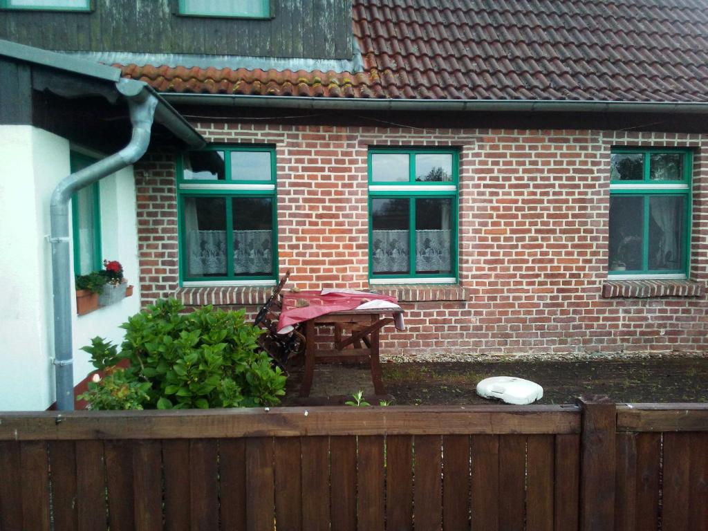 a table in front of a house with a fence at Her - "Auf dem Käubs" 