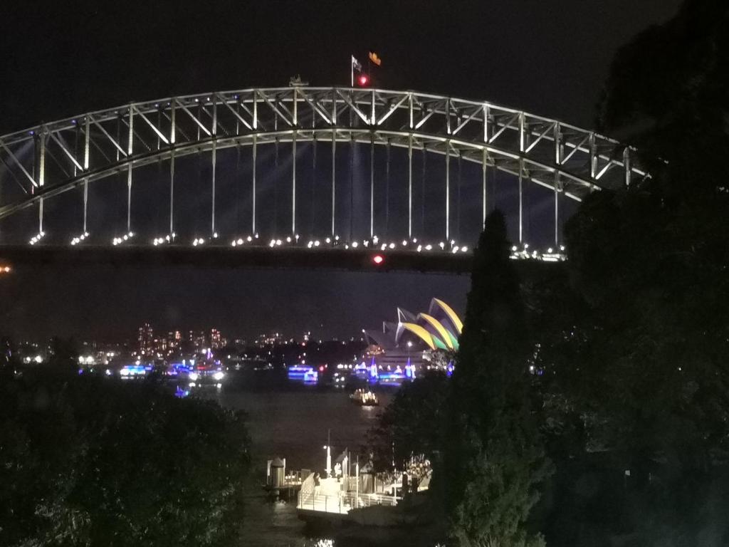 a view of the sydney harbour bridge at night at Harbourside7 - modern 1br unit with fab views in Sydney