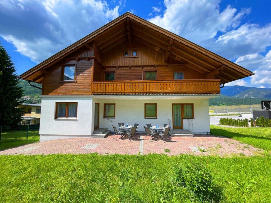 ein Haus mit einem Holzdach und einer Terrasse in der Unterkunft Welcoming apartment in Schladming in Schladming