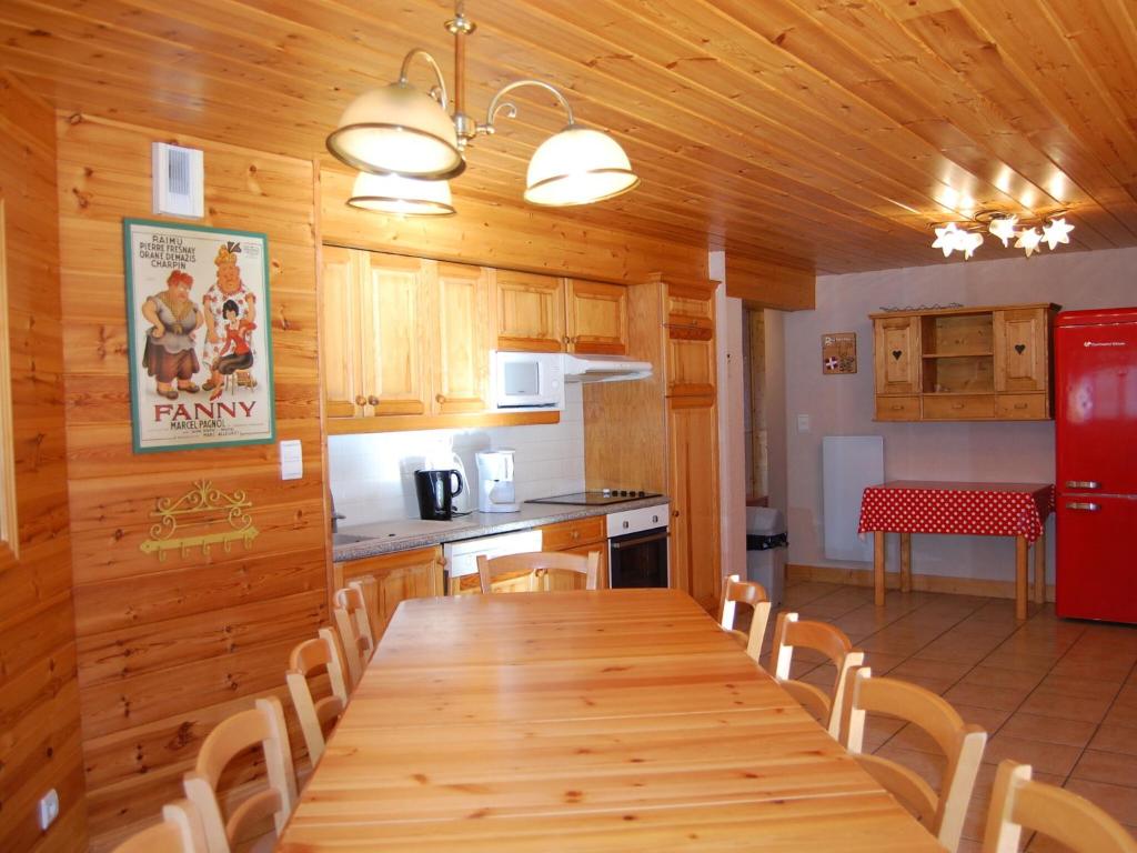 a kitchen with a long wooden table and chairs at Spacious holiday home near center of Champagny in Le Villard
