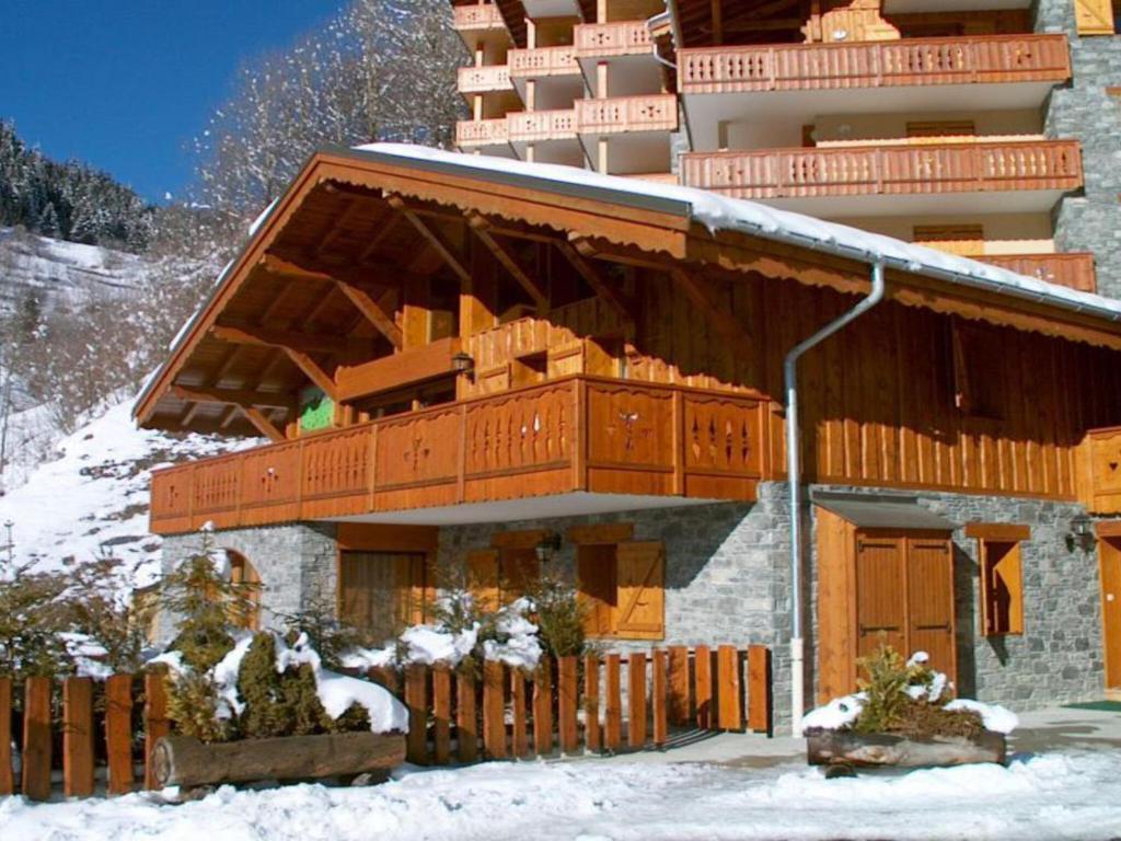 a building in the snow in front of a building at Spacious holiday home near center of Champagny in Le Villard