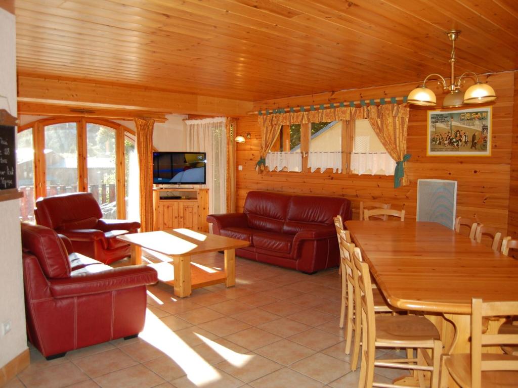 a living room with a couch and a table at Spacious holiday home near center of Champagny in Le Villard