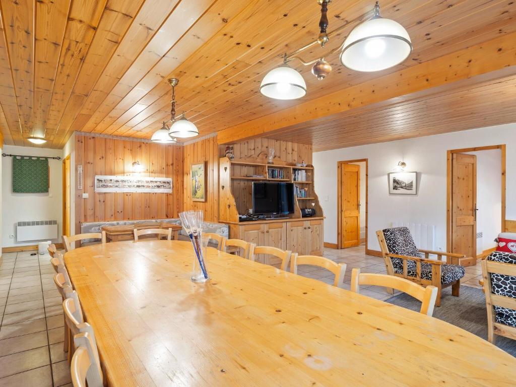 a dining room and kitchen with a wooden table and chairs at Spacious holiday home near center of Champagny in Le Villard