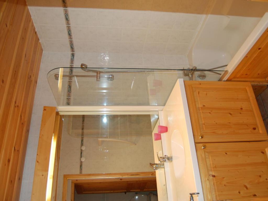 a bathroom with a glass shower in a room at Spacious holiday home near center of Champagny in Le Villard
