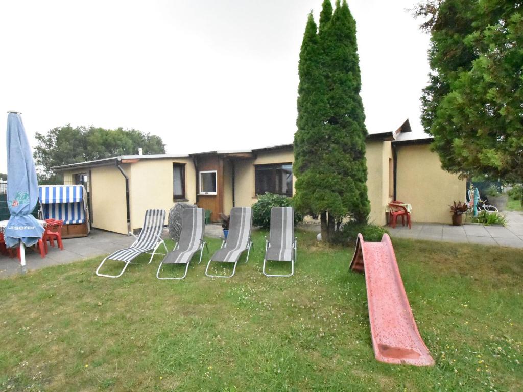 a group of playground equipment in a yard at Lovely Farmhouse in K hlungsborn near sea in Kühlungsborn