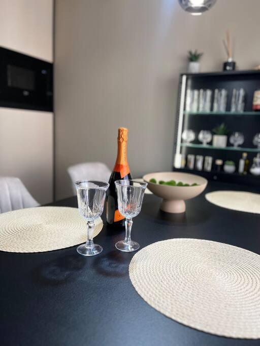 a table with two glasses and a bottle of wine at Apartmán Artemis in Košice