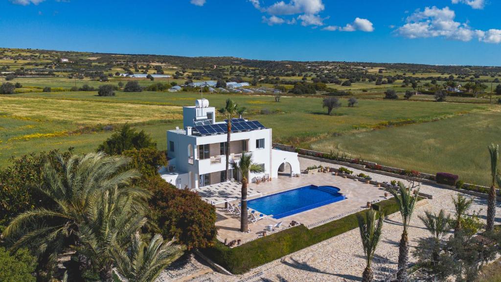 an aerial view of a house with a swimming pool at Villa Chrysta in Ayios Theodhoros