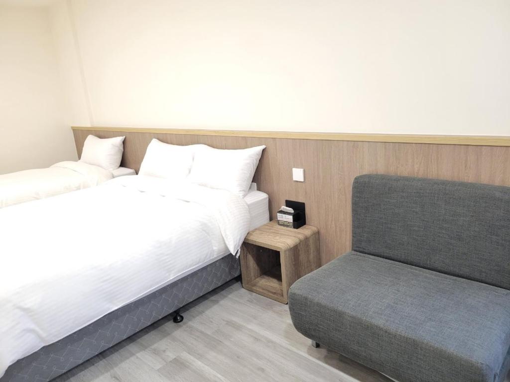 Postel nebo postele na pokoji v ubytování 悠而行旅