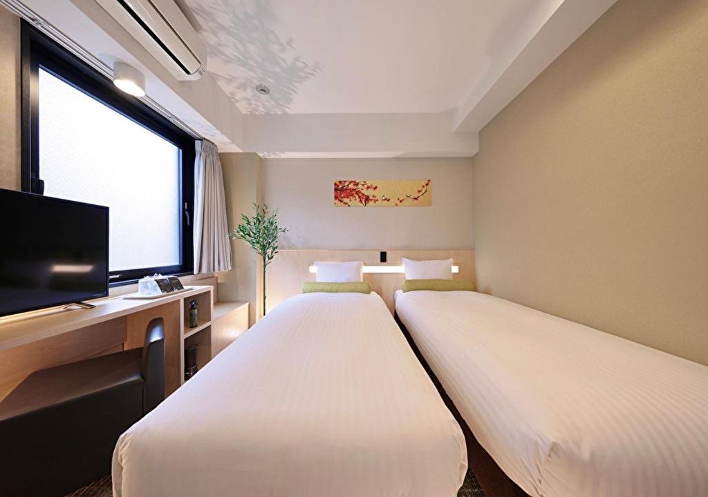 Postel nebo postele na pokoji v ubytování Shinsaibashi-Higashi Crystal Hotel