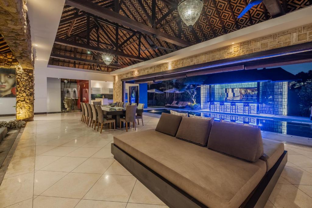 a living room with a couch and a table at Villa Samudra Raya in Seminyak