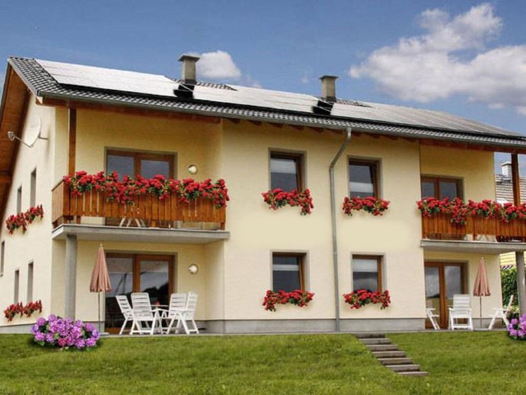 a house with red flowers on the balcony at Lovely Apartment in M rz with Garden Balcony in Lahr