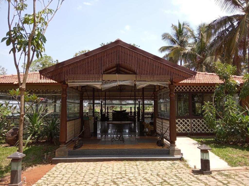 a gazebo with a table in it at Discovery Village Resorts in Begūr