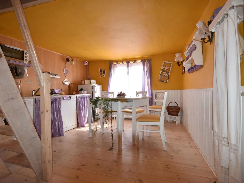 a kitchen with a table and chairs in a room at Beautiful Apartment in Damgarten with Garden in Ribnitz-Damgarten