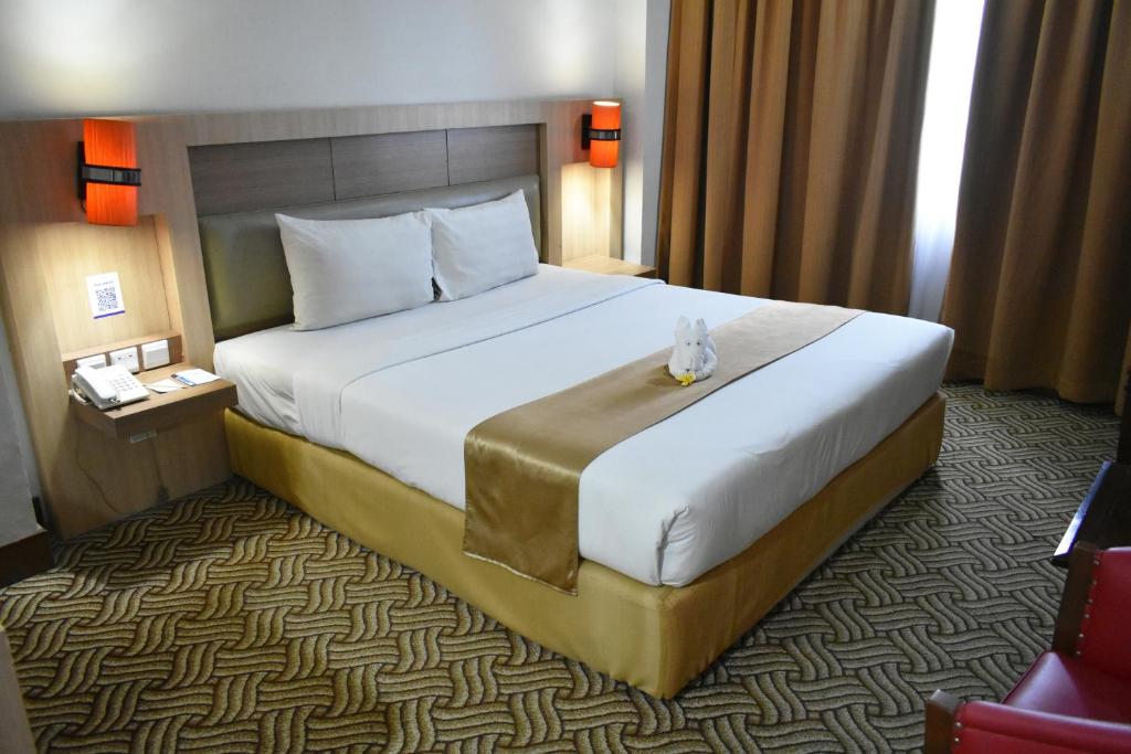 Postel nebo postele na pokoji v ubytování Abadi Hotel Malioboro Yogyakarta