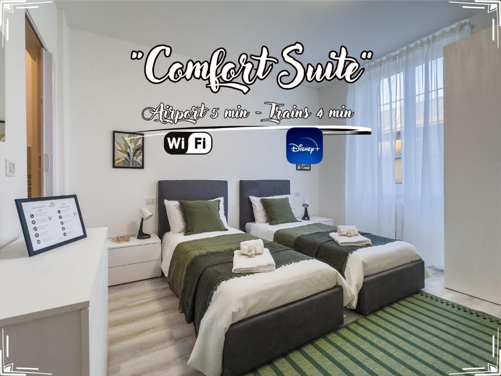 a bedroom with two beds and a sign that reads conflict suite at [Comfort Suite] Airport 5min • A/C • Disney+ in Genova