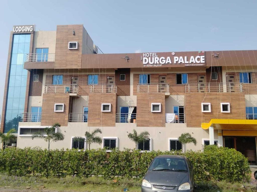 a car parked in front of a building at OYO Durga Palace in Sāngli