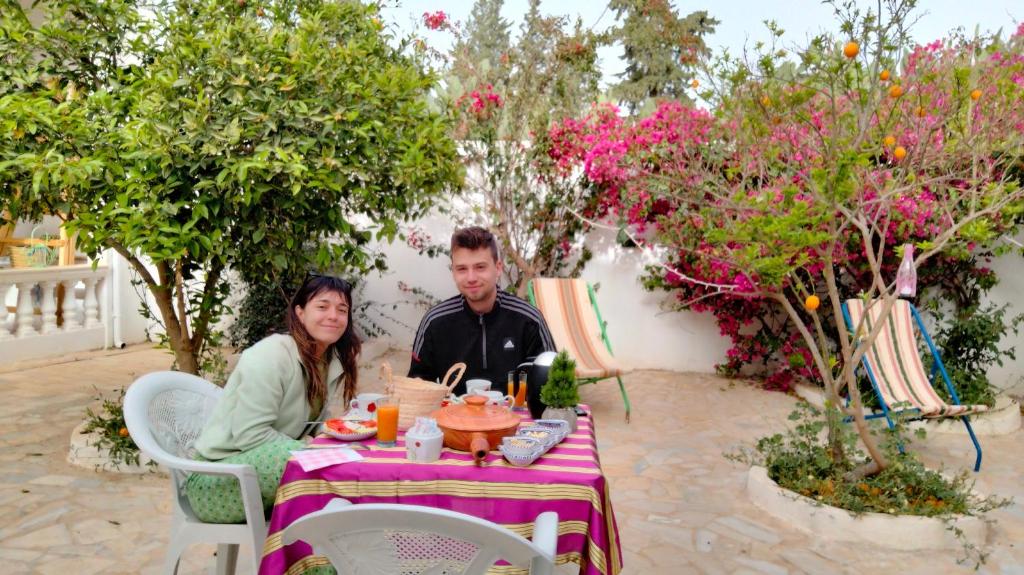 a man and a woman sitting at a table at Henchir ejdoud in Kairouan