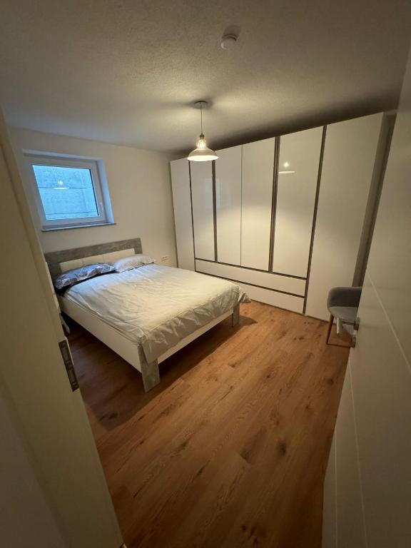 a bedroom with a bed and a window at Neues Apartment Ehingen in Ehingen