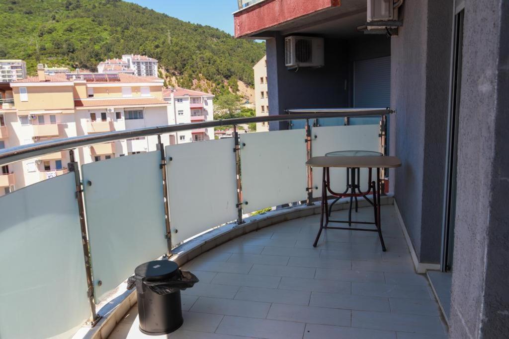 a balcony with a stool and a table on a building at Apartment Nadja in Budva