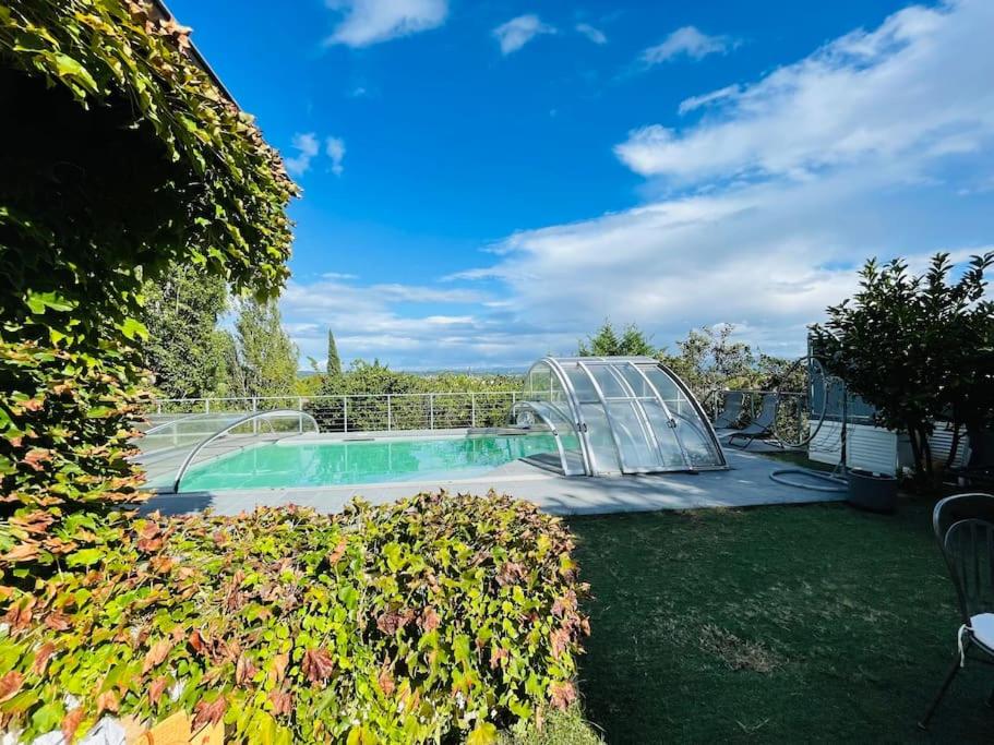 a swimming pool with a glass fence around it at Villa avec piscine au cœur de la ville in Tournon-sur-Rhône