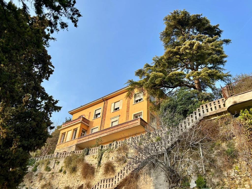 a yellow building on the side of a hill at Villa Manzati in Verona