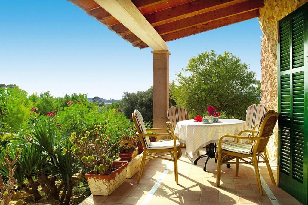 a patio with a table and chairs and some plants at Holiday homes Santa Margalida - BAL01422-FYB in Santa Margalida