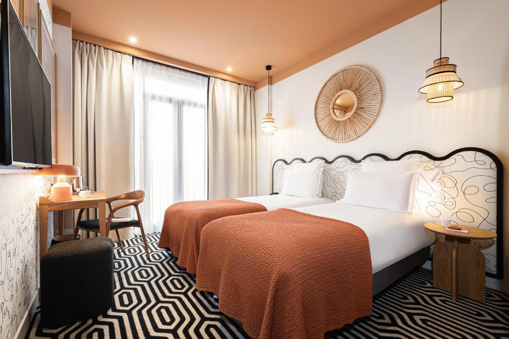 a hotel room with a bed and a window at Albert 1er in Nice