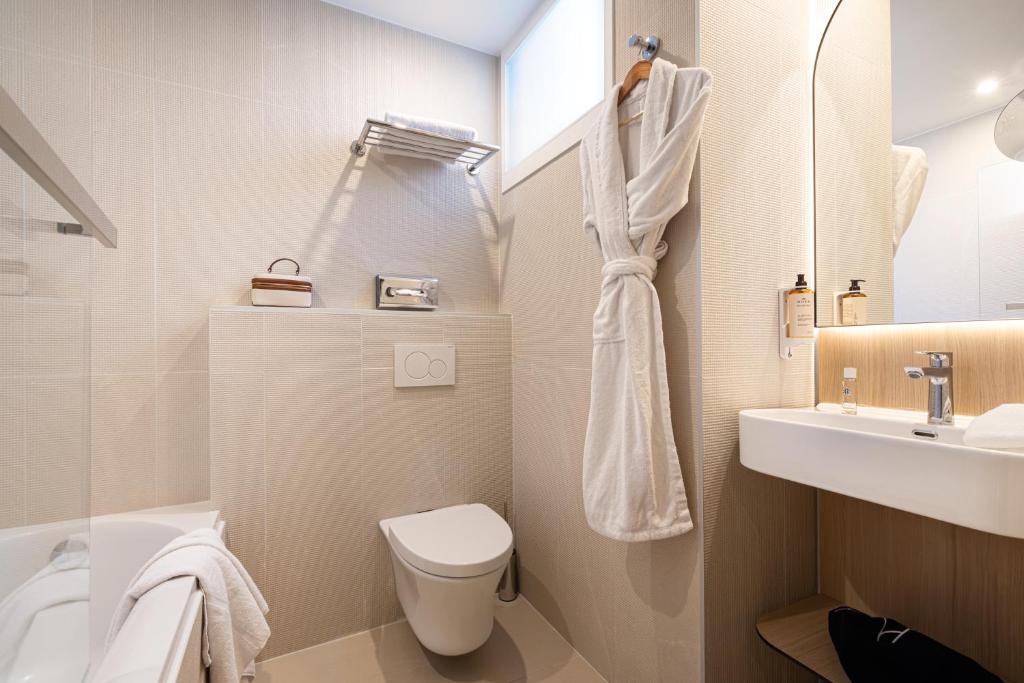 a bathroom with a toilet and a sink at Albert 1er in Nice