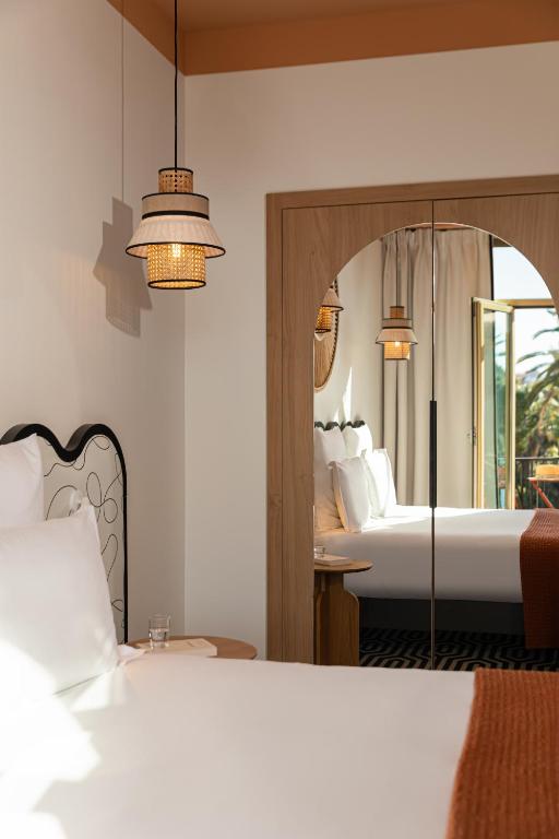 a bedroom with a bed and a large mirror at Albert 1er in Nice