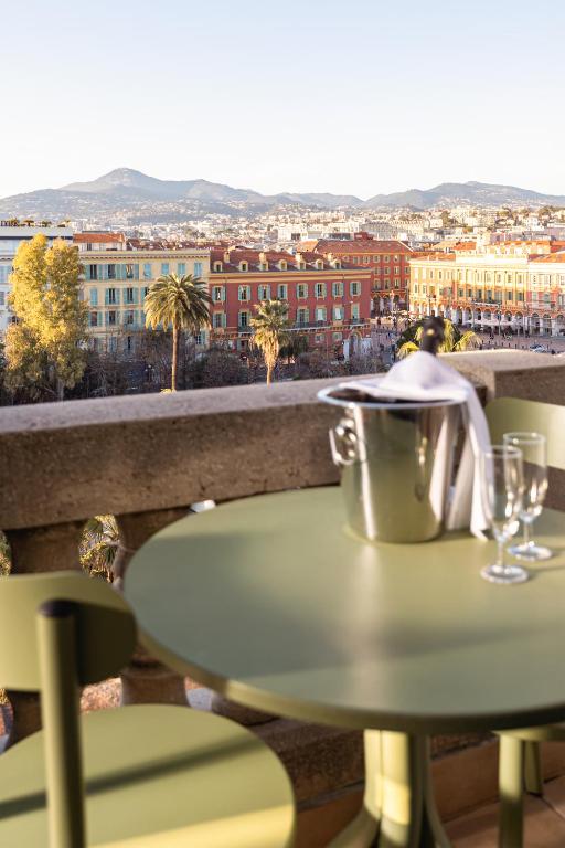 a table on a balcony with a view of a city at Albert 1er in Nice