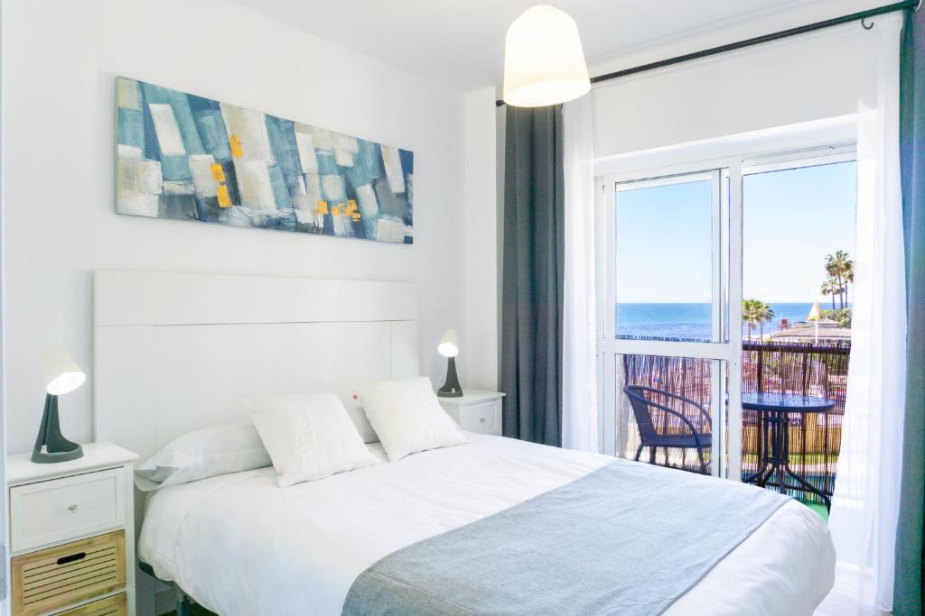 a bedroom with a bed and a view of the ocean at Mijas Sea Views Apartment in Mijas Costa