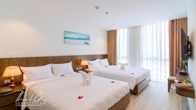 Postel nebo postele na pokoji v ubytování Greenery Hotel