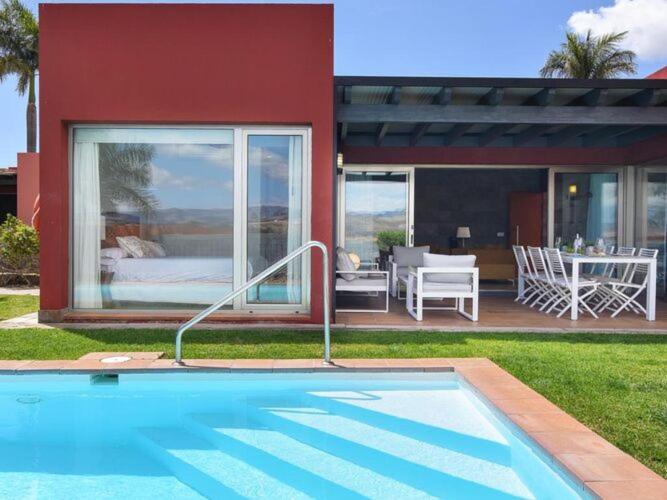 a house with a swimming pool in front of a house at Holiday Home Maspalomas - LPA03100h-O in Maspalomas