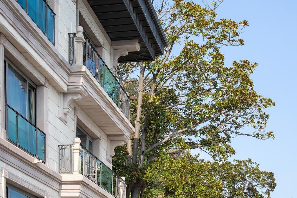 a building with a tree in front of it at MFB Tarabya Hotel in Istanbul