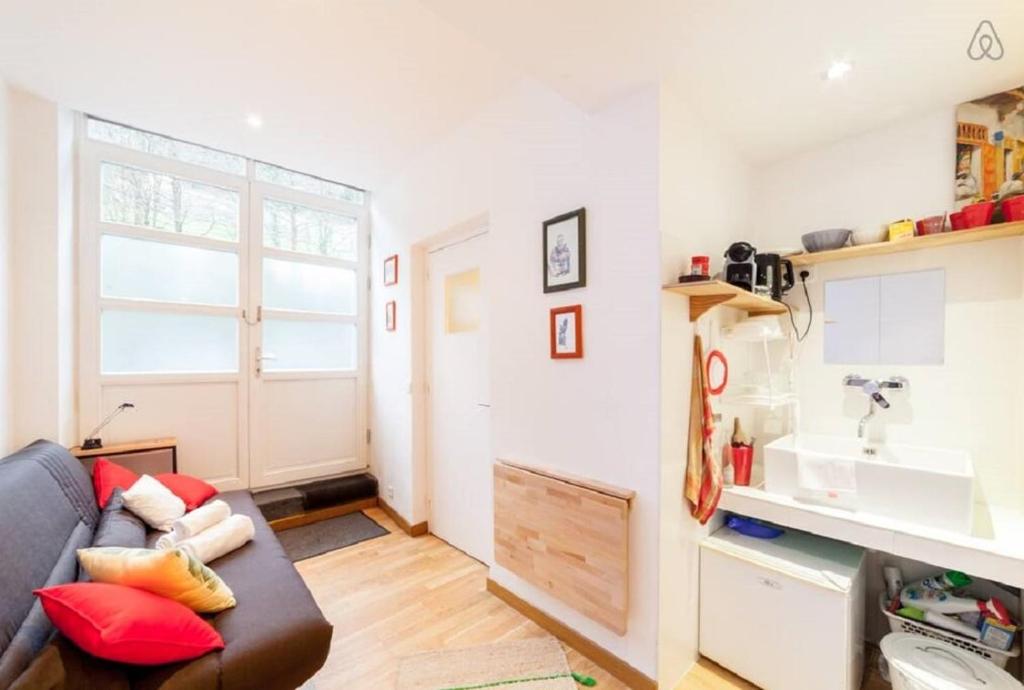 a living room with a couch and a sink at Incredible location - in the heart of old town AIL in Lyon