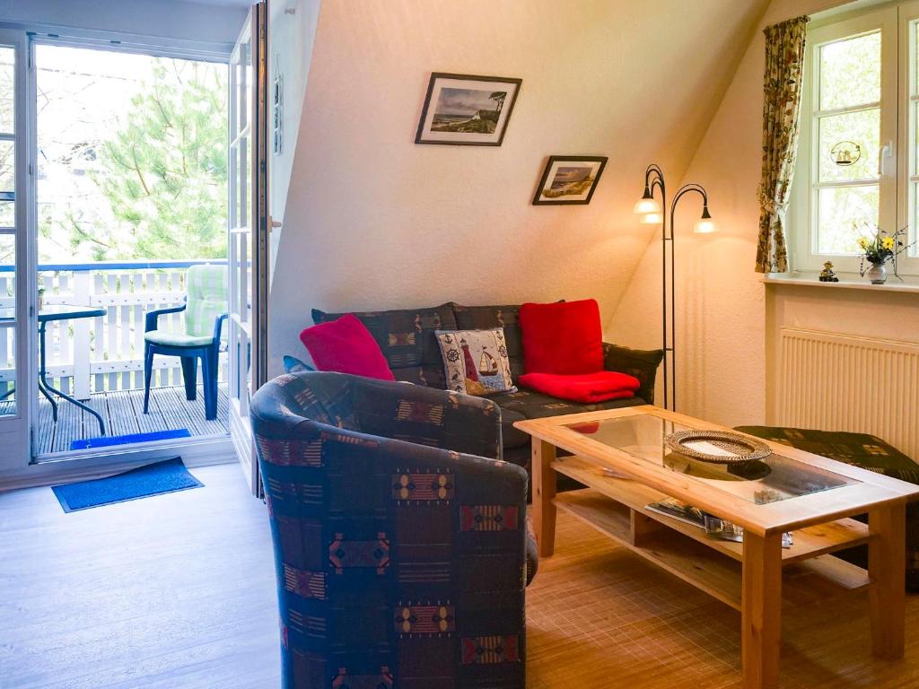 a living room with a couch and a table at Achtern Diek 7b - Wohnung 8 in Groß Kirr