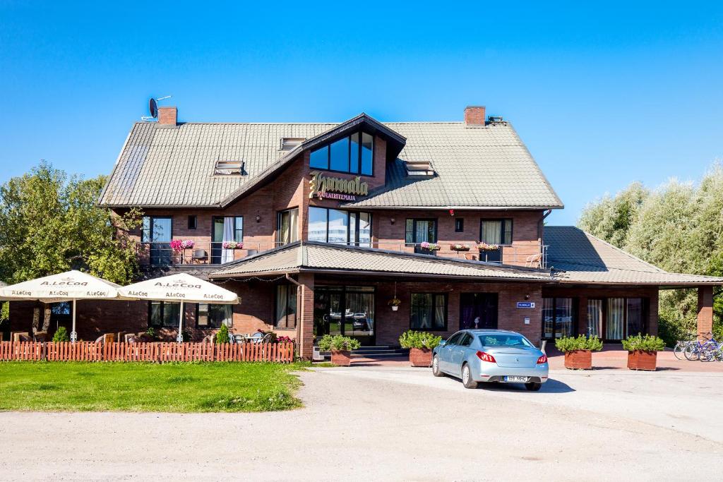 a house with a car parked in front of it at Humala Guest House in Tallinn