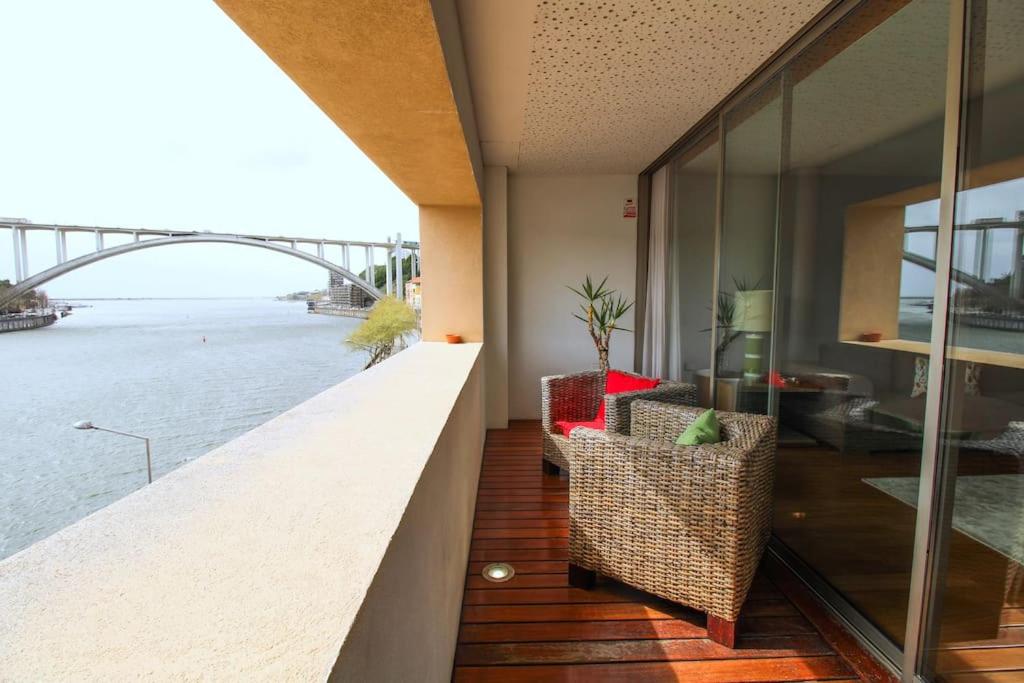a balcony with a view of the river and a bridge at Refúgio Rio Douro in Porto