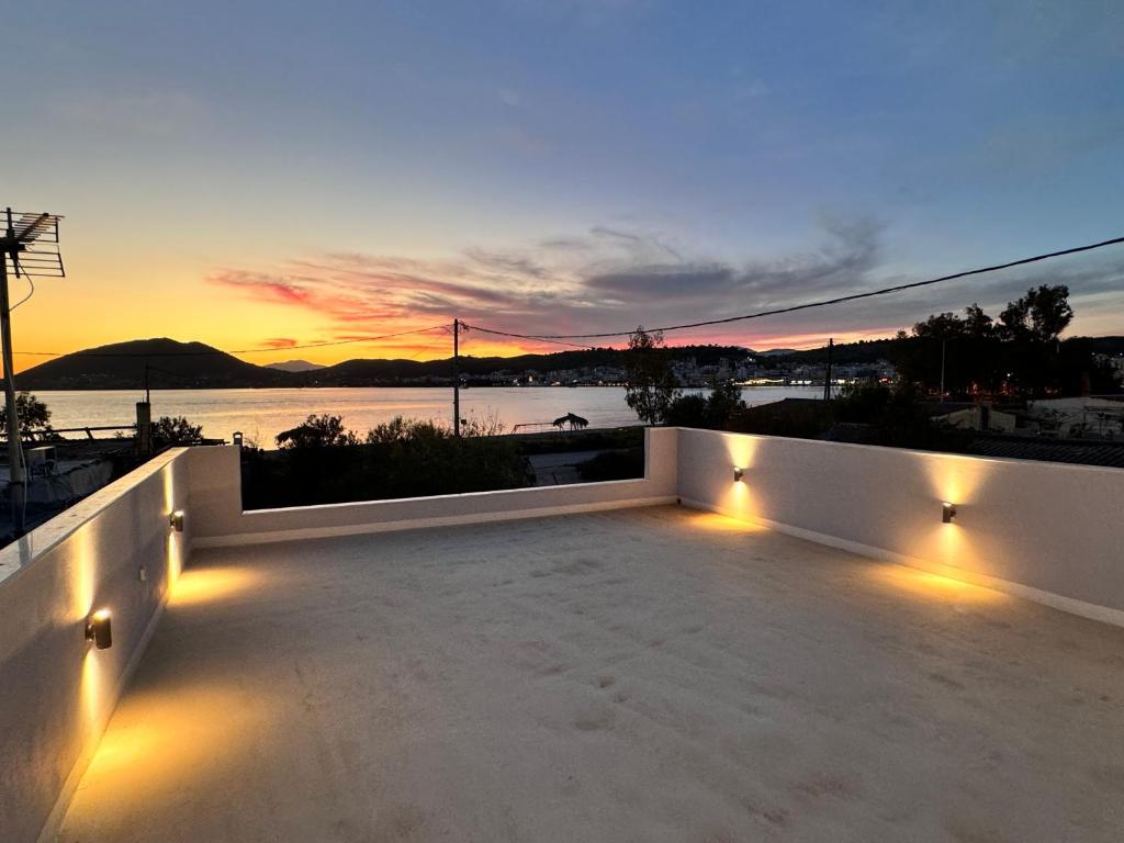 a sunset on the roof of a house with lights at Casa Nova in Salamís