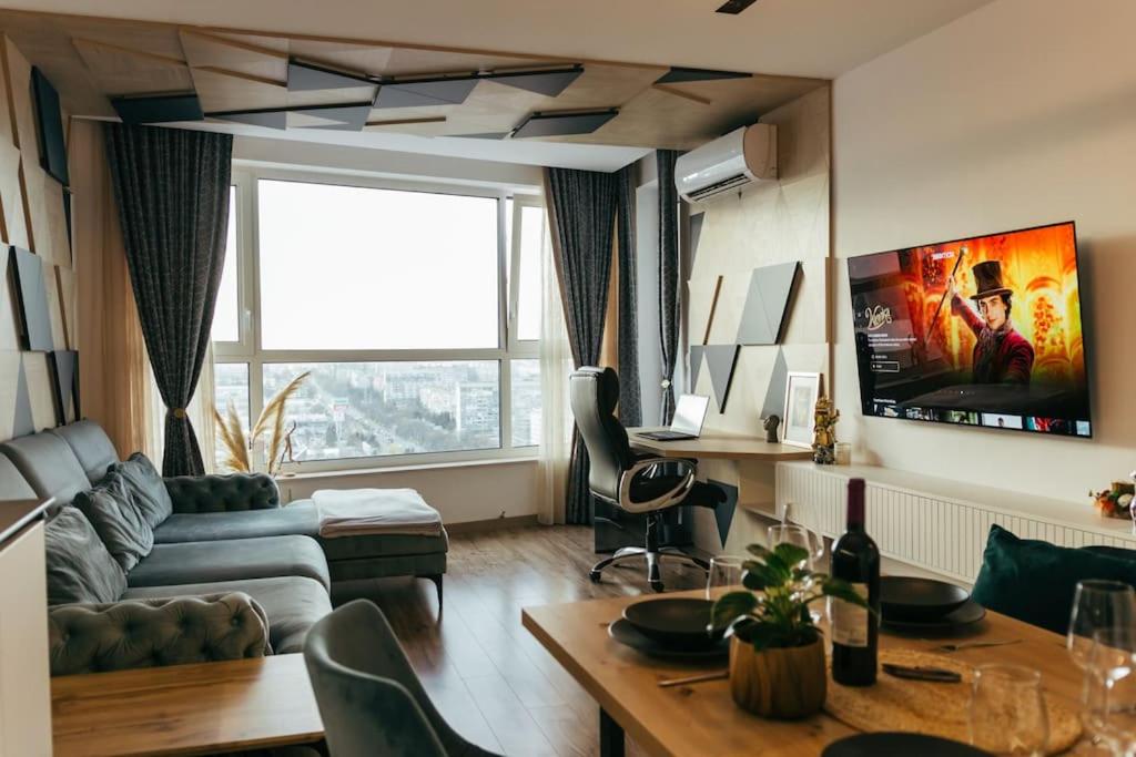 a living room with a couch and a table at Luxury apartment in Central Park Burgas with amazing view + private parking space in Burgas City